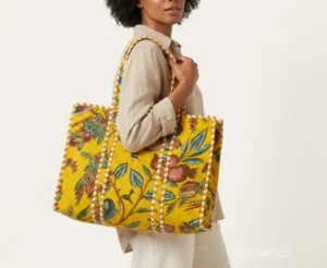 Close-up of the exotic jungle print detailing, traditional hand-running Kantha embroidery stitches, extra deep 14-inch bottom gusset base, and built-in inside pocket on an Indian cotton tote bag.