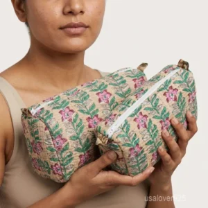 Close-up of the handcrafted beige floral print detailing, dense vertical quilted stitching rows, waterproof internal plastic lining, and built-in inside slots on an Indian cotton cosmetic caddy pouch.