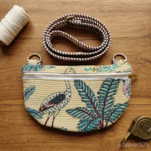 Woman traveling through an airport wearing a reversible Beige Jungle Print Quilted Mini Purse as a secure front chest sling.