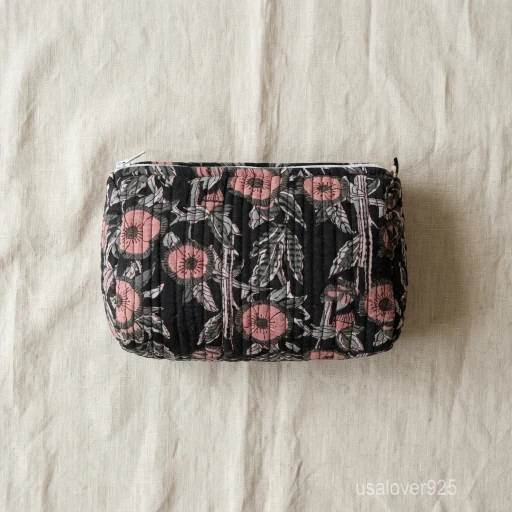 A three-piece nesting set of Black Block Print Quilted Cotton Toiletry Bags neatly arranged on a clean vanity counter showing the large, medium, and small size profiles.