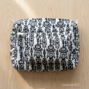 A three-piece nesting set of Black Floral Quilted Cotton Toiletry Bags neatly arranged on a clean vanity counter showing the large, medium, and small size profiles.