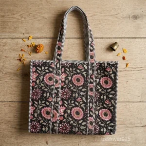 A person carrying a large Black Hand Block Print Quilted Cotton Tote Bag comfortably over their shoulder during a daily school commute.