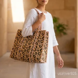 Close-up of the exotic jungle print detailing, smooth premium pure cotton weave texture, and comfortable 13-inch handles on an Indian shopper bag.