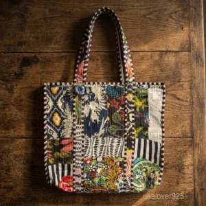 Black Patchwork Print Quilted Cotton Tote Bag with shoulder straps showing the assorted floral and geometric block patterns.