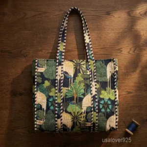A shopper carrying the Black Peacock Palace Quilted Tote Bag by the wide straps, showcasing its generous packing capacity and vibrant bohemian accessory style while walking outdoors.