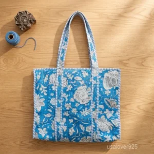 A person carrying a massive Block Print Quilted Cotton Tote Bag comfortably over their shoulder during a coastal beach vacation getaway trip.