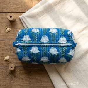A three-piece nesting set of Blue Block Print Quilted Cotton Toiletry Bags neatly arranged on a clean vanity counter showing the large, medium, and small size profiles.