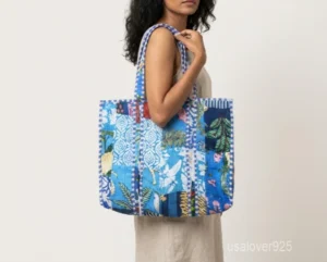Close-up of the hand block floral prints, dense parallel line quilted stitching, and roomy side gusset on an Indian cotton shopper bag.