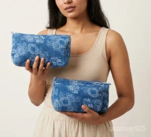 A three-piece nesting set of Blue Floral Quilted Cotton Toiletry Bags neatly arranged on a clean vanity counter showing the large, medium, and small size profiles.
