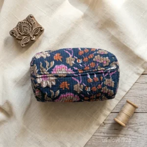 A three-piece nesting set of Blue Floral Quilted Cotton Toiletry Bags neatly arranged on a clean bathroom vanity counter showing the large, medium, and small size profiles.