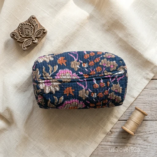 A three-piece nesting set of Blue Floral Quilted Cotton Toiletry Bags neatly arranged on a clean bathroom vanity counter showing the large, medium, and small size profiles.