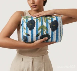 Close-up of the handcrafted blue floral print detailing, dense vertical quilted stitching rows, waterproof internal plastic lining, and built-in inside slots on an Indian cotton cosmetic caddy pouch.
