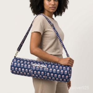 Close-up of the handcrafted blue block print detailing, dense quilted stitching tracks, heavy-duty metal clasps, and adjustable crossbody strap on an Indian cotton fitness mat bag.