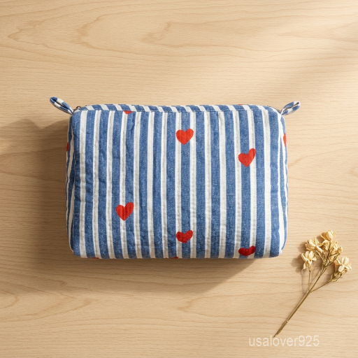A traveler organizing the Blue Heart Makeup Pouch Set on a bedroom vanity desk, displaying its multi-size utility and bohemian aesthetic travel style.