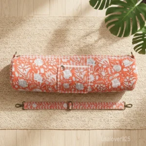 Close-up of the secure outer zipper pocket, premium metal hardware, and full-length zipper closure on a cotton yoga mat bag.