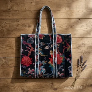 A person carrying a large Dark Vintage Floral Velvet Quilted Tote Bag comfortably over their shoulder during a casual evening outing.
