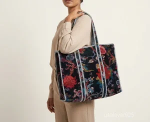 Close-up of the deep velvet floral print side, dense parallel line quilted stitching rows, interior square pocket, and clean solid color option on a reversible Indian velvet purse.