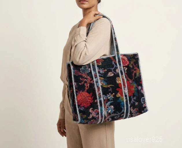 Close-up of the deep velvet floral print side, dense parallel line quilted stitching rows, interior square pocket, and clean solid color option on a reversible Indian velvet purse.