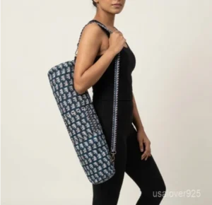 Close-up of the handcrafted indigo blue elephant print detailing, dense quilted stitching texture lines, robust adjustable strap attachments, and clean zip track on an Indian cotton Pilates carrier bag.