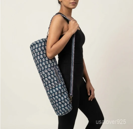 Close-up of the handcrafted indigo blue elephant print detailing, dense quilted stitching texture lines, robust adjustable strap attachments, and clean zip track on an Indian cotton Pilates carrier bag.