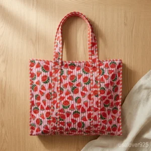 Woman walking through an outdoor market carrying an extra large Embroidered Watermelon Quilted Cotton Tote Bag packed with books and essentials.