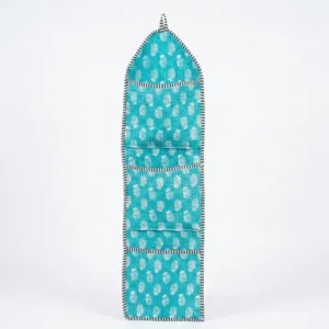 Close-up of authentic turquoise firozi block printing on a quilted cotton wall pocket.