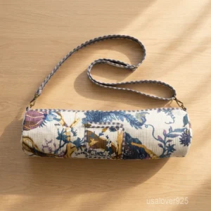 Woman walking to a workout studio carrying a Floral Quilted Cotton Yoga Mat Bag comfortably as a crossbody sling.