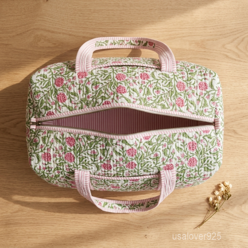 Close-up of the handcrafted floral block print detailing, dense quilted stitching texture lines, robust handle attachments, and full-length secure zip on an Indian cotton travel duffle.