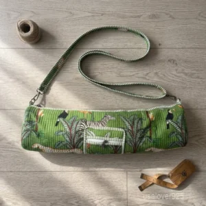 An active practitioner carrying the Forest Print Quilted Yoga Mat Bag over the shoulder while commuting, displaying its comfortable fit and vibrant studio-ready look.