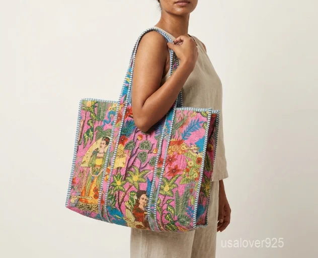 A person carrying a large Frida Kahlo Inspired Quilted Cotton Tote Bag comfortably over their shoulder during a casual outdoor art festival visit.