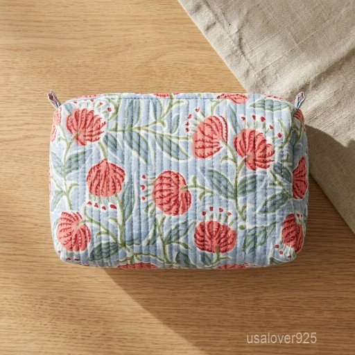 Close-up of the handcrafted gray floral print detailing, dense vertical quilted stitching rows, waterproof internal plastic lining, and built-in inside slots on an Indian cotton cosmetic caddy pouch.