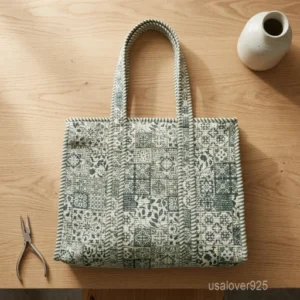 A person carrying a Green and White Patchwork Quilted Cotton Tote Bag comfortably over their shoulder during a casual outdoor market run.