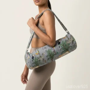 Close-up of the handcrafted grey zebra print detailing, dense tropical palm quilted stitching texture lines, robust adjustable strap attachments, and clean zip track on an Indian cotton Pilates carrier bag.