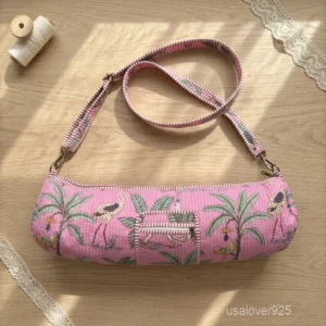 An active practitioner carrying the Hand Block Print Pink Yoga Mat Bag over the shoulder while commuting, displaying its comfortable fit and vibrant studio-ready look.