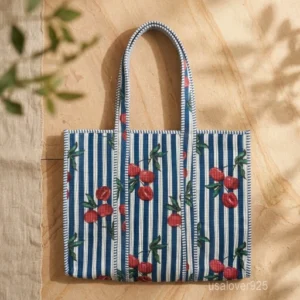 A person carrying a large Hand Block Print Quilted Cotton Tote Bag comfortably over their shoulder during a weekend getaway travel trip.
