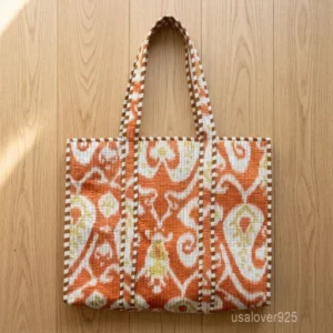 A person carrying a large Hand Block Print Quilted Cotton Tote Bag comfortably over their shoulder during a casual weekend travel getaway.