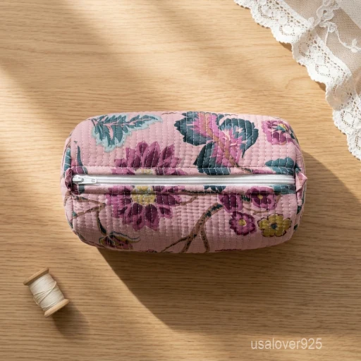 A three-piece nesting set of Hand Block Printed Quilted Cotton Cosmetic Bag Set neatly arranged on a clean bathroom vanity counter showing the large, medium, and small size configurations.