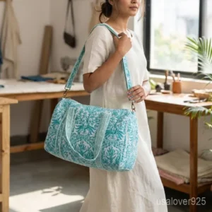 A traveler carrying the Green Floral Quilted Cotton Weekender Bag by the wide straps, showcasing its generous packing capacity and vibrant bohemian travel style.