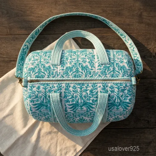 Close-up of the handcrafted green floral block print detailing, dense quilted stitching texture lines, robust handle attachments, and clean zip track on an Indian cotton travel duffle.