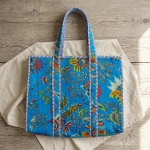 A person carrying a large Handmade Block Print Quilted Indian Cotton Tote Bag comfortably over their shoulder during a casual weekend trip.