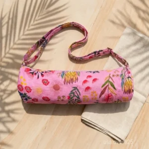 Close-up of the handcrafted pink floral wildflower print detailing, dense quilted stitching texture lines, robust adjustable strap attachments, and clean zip track on an Indian cotton Pilates carrier bag.