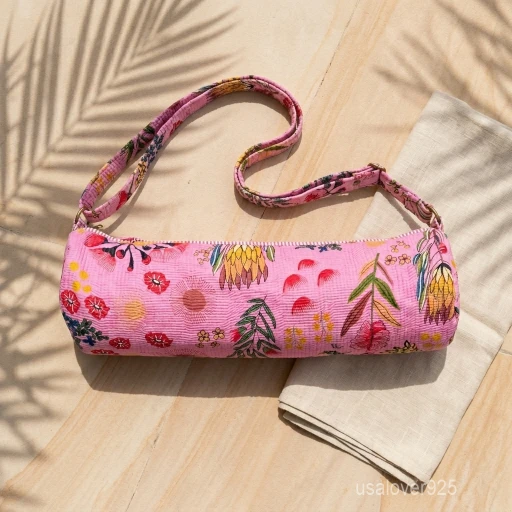 Close-up of the handcrafted pink floral wildflower print detailing, dense quilted stitching texture lines, robust adjustable strap attachments, and clean zip track on an Indian cotton Pilates carrier bag.