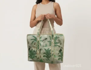 Close-up of the regional hand block print detailing, dense parallel line quilted stitching rows, extra-wide 7-inch deep bottom gusset base, and comfortable handles on an Indian cotton tote bag.