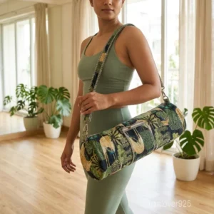 Close-up of the convenient outer stash pocket, top closure system, and premium quilted stitching on a green cotton yoga bag.
