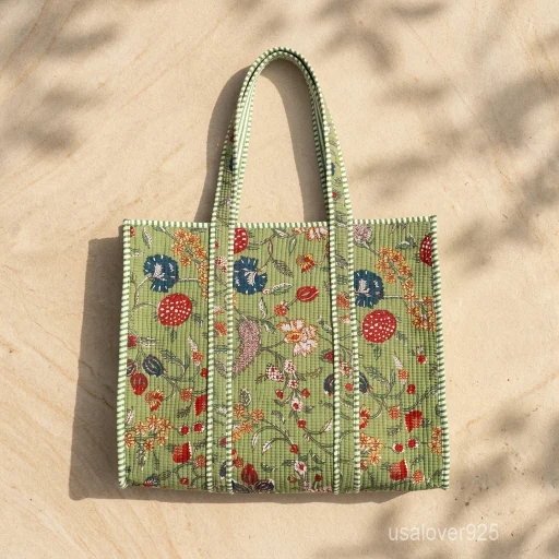 A person carrying a large Multicolor Floral Block Print Quilted Cotton Tote Bag comfortably over their shoulder during an outdoor weekend getaway travel trip.