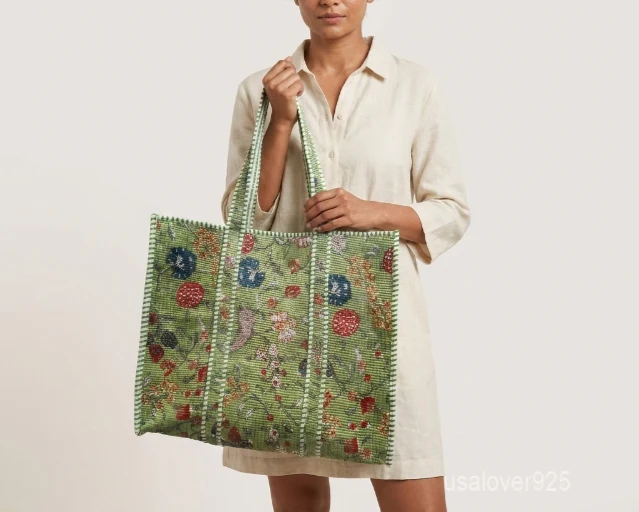 Close-up of the multicolor block print detailing, dense parallel line quilted stitching rows, supportive 5.5-inch bottom gusset base, and comfortable handles on an Indian cotton tote bag.