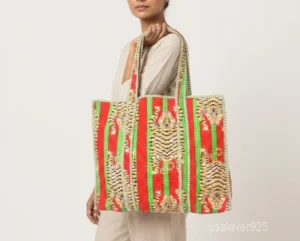 Close-up of the multicolor block print detailing, dense parallel line quilted stitching rows, and comfortable 13-inch shoulder handles on an Indian cotton tote bag.