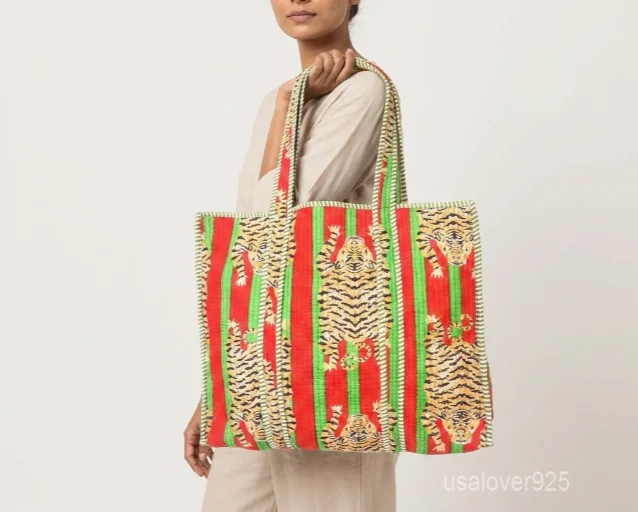 Close-up of the multicolor block print detailing, dense parallel line quilted stitching rows, and comfortable 13-inch shoulder handles on an Indian cotton tote bag.