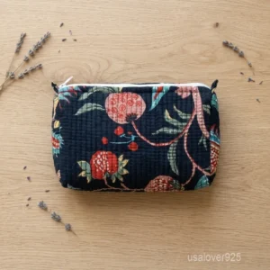 A three-piece nesting set of Navy Blue Floral Quilted Cotton Toiletry Bags neatly arranged on a clean bathroom vanity counter showing the large long-profile, medium, and small size configurations.
