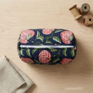 A three-piece nesting set of Navy Blue Floral Quilted Cotton Toiletry Bags neatly arranged on a clean bathroom vanity counter showing the large long-profile, medium, and small size configurations.
